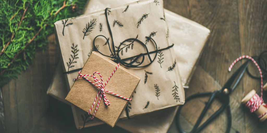 A picture of presents wrapped in festive decorations and brown paper